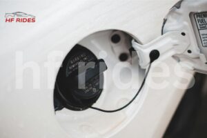 Open car gas cap showing warning label
