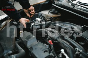 Mechanic inspecting car undercarriage for fuel line issues