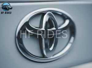 Close-up of the Toyota emblem on the front of a car, highlighting the brand's recognizable symbol.