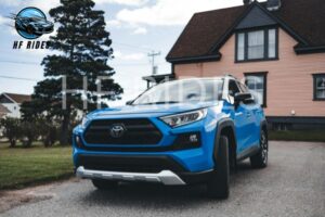 Front view of a blue Toyota RAV4, showcasing its sleek design and distinctive grille.