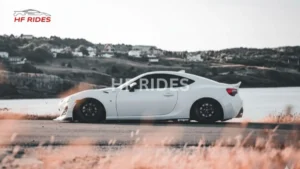 A side view of a white car running at the high speed on the highway - how long does it take to align a car