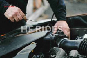 Car mechanic checking engine 