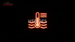 Car coolant temp warning light in a black background